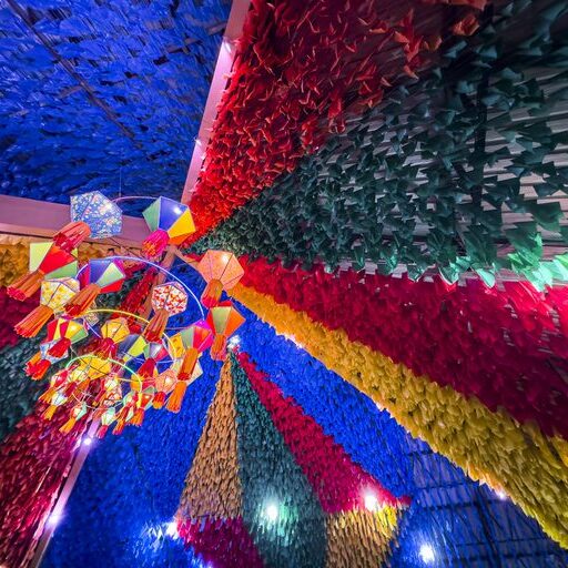 Colorful festival ceiling with hanging decorations.